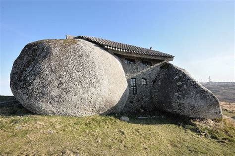 A little stone house built between 2 stone bolders | House on the rock, Unusual buildings, Stone ...