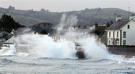 Britain battered by worst tidal surge in 60 years: Sea walls breached as 20ft waves smash string ...