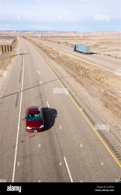 Vehicles on Interstate 70 in Southern Utah. The San Rafael Swell is in the background Stock ...