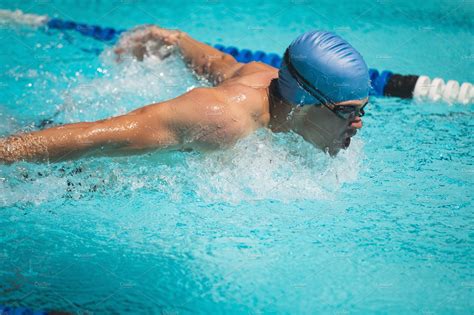 Swimmer swimming butterfly stroke | Stock Photos ~ Creative Market