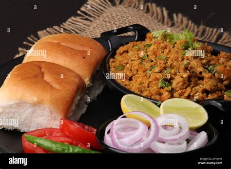 Masala Anda Bhurji or Spicy Indian scrambled eggs with bread or Bun Pav ...