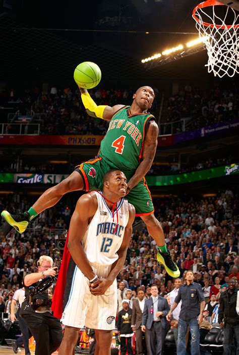 Nate Robinson leaps over Dwight Howard during the... - SI Photo Blog