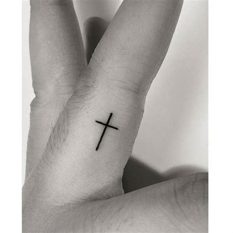 Minimalistic cross tattoo done on the finger.