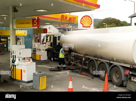 A petrol tanker driver working refilling shell petrol station Stock ...