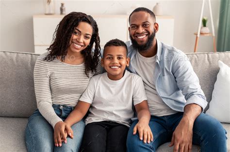 Portrait of young happy black family smiling at home Stock Photo by ...