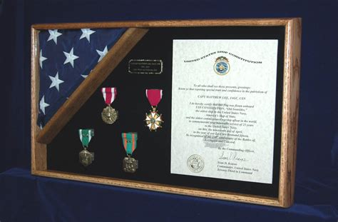 Military medals in an oak framed shadow box with a flag and certificate. Made by ShadowBoxUSA ...