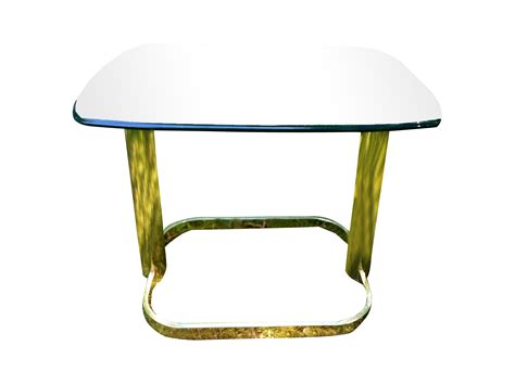 a glass table with gold metal legs and a white top, on a white background
