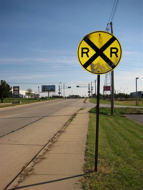 An RXR marking may be painted on a paved road approaching a crossing.