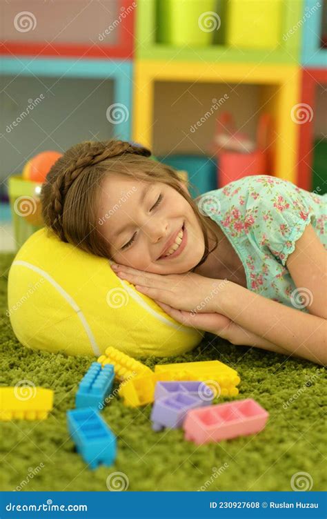 Cute Little Girl Lying on the Floor with Toys Stock Photo - Image of carpet, lifestyle: 230927608