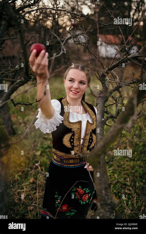 A closeup of golden braid hair girl in Serbian traditional costume ...