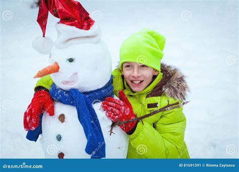 Fun, Happy Kid Playing with Snowman in Winter Park Stock Image - Image ...