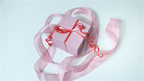 Wrapped with ribbon gift box placed on table · Free Stock Photo