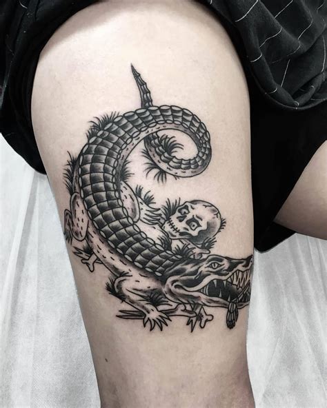 a woman's thigh with a dragon tattoo on it