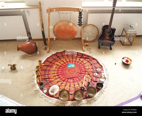 Sound therapy set up with different sound instruments and yoga mats around Stock Photo - Alamy