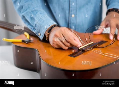 Restring classical guitar concept. The man restring his classical guitar Stock Photo - Alamy