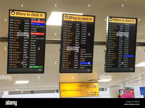 Departure boards at Glasgow Airport showing cancelled flights Stock Photo - Alamy