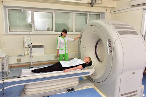 Tomograph/The doctor gives the last instructions to the patient before a full-body scan on ...