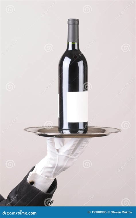 Butler Holding Wine Bottle On Tray Stock Image - Image of formalwear, silver: 12388905