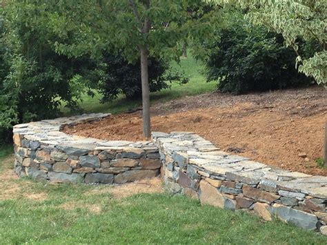 Dry stack field stone retaining wall on gravel bed : r/stonemasonry