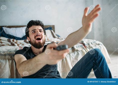 Young Handsome Man Watching TV on a Floor at Home Stock Image - Image of angry, relax: 89107547