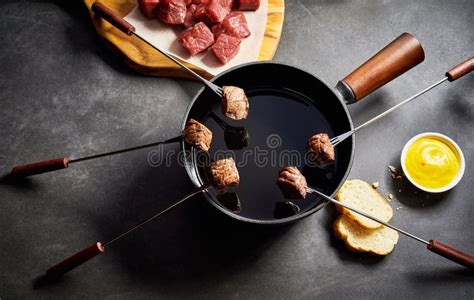 Cooking Cubes of Beef in Fondue Pot of Hot Oil Stock Photo - Image of ...