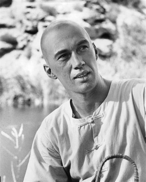 a black and white photo of a man holding a tennis racket