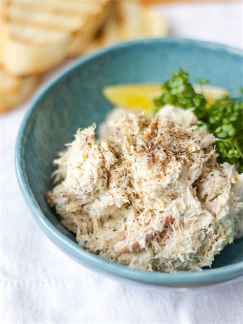 Pile of Smoked Mackerel pate in a green bowl with cress and a wedge of ...