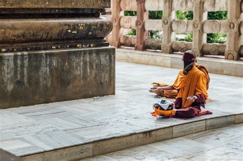 Premium Photo | Indian buddhist monk in meditation near the bodhi tree near mahabodhi temple ...