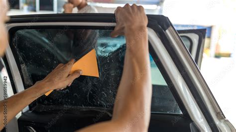 Technician Installing car window tint. Car window tinting series. Car ...