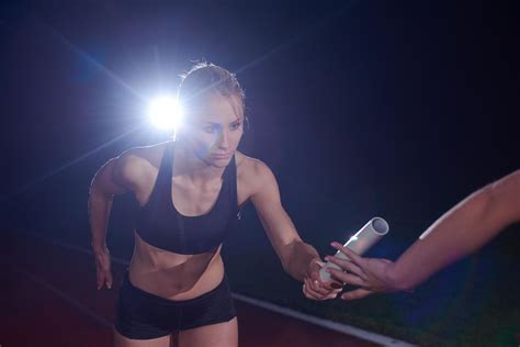 athletic runners passing baton in relay race 12651062 Stock Photo at ...