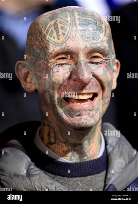 A Leeds United fan with his face covered in tattoos in the stands Stock ...