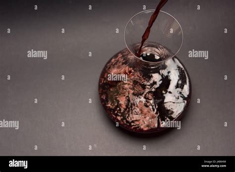 Decanting red wine Stock Photo - Alamy