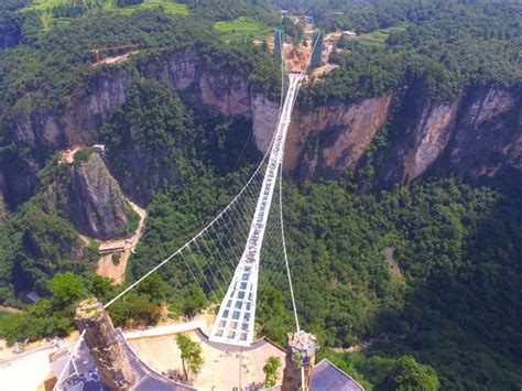 People visit a glass bridge at a gorge as it opens to public in ...