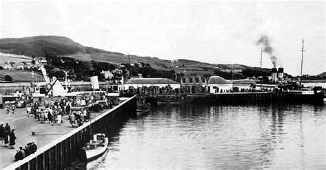 Old photograph of people and boats at the pier in Campbeltown , Argyll ...