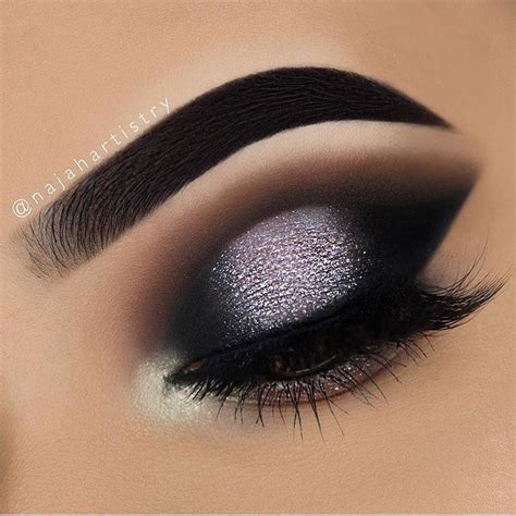 Dramatic modern smokey eye. Black dark eye shadow with silver glitter ...