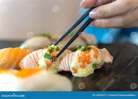 Eating Sushi with Chopsticks. Fresh Sushi Japanese Food in Restaurant Stock Image - Image of ...