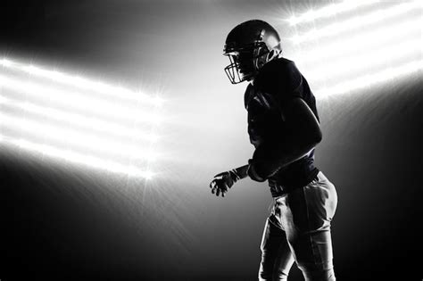 Premium Photo | Composite image of silhouette american football player walking