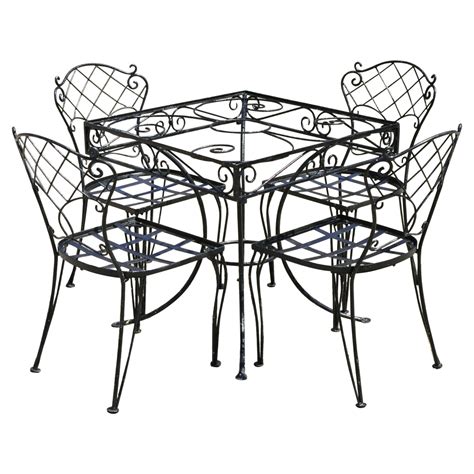 Lyrical Wrought Iron Patio Table and Chairs at 1stDibs