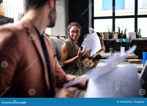 Portrait of Young Business People with Laptop Working Indoors in Office ...