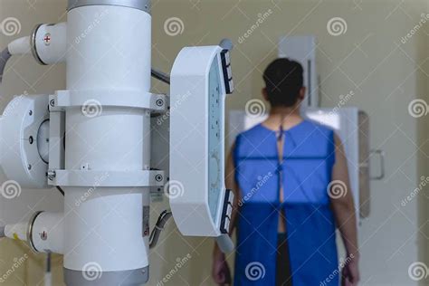 A Asian Man Standing in a Medical Gown Undergoes a Chest X-ray ...