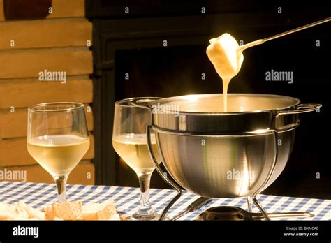 Cheese fondue and white wine Stock Photo - Alamy