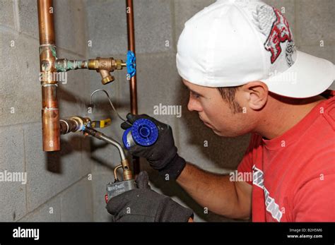 Plumber installing copper water piping for new residential home Stock Photo - Alamy