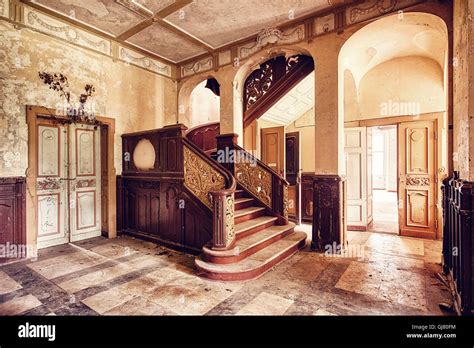 entrance hall with stairway in an abandoned castle Stock Photo - Alamy