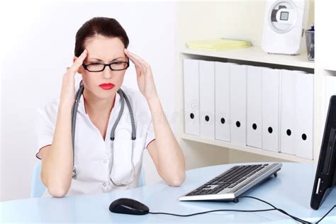 Female Doctor Having Headache. Stock Photo - Image of depressed, brunette: 22145028