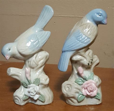 2 Painted Ceramic Blue Bird Figurines sitting on a branch with flowers ...