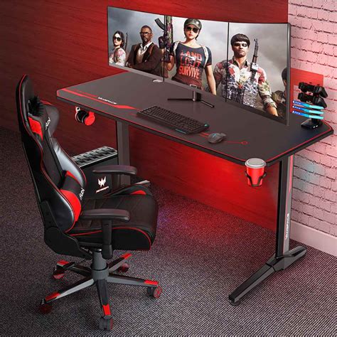 a computer desk with two monitors and a gaming chair