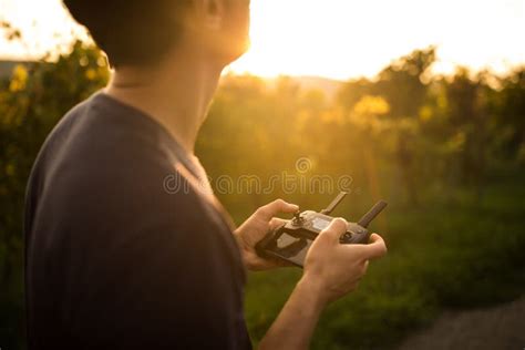 Young man flying a drone stock photo. Image of remote - 170646740