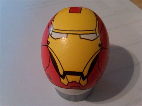 an egg shaped like iron man sitting on top of a table