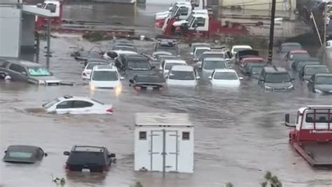 Cars swept down swamped roads as floods wreak havoc across San Diego ...