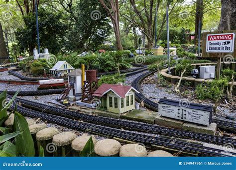 Tiny Houses Along a Set of Miniature Railroad Tracks with Lush Green ...